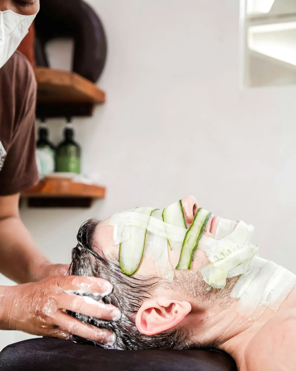 Man receiving a facial mask during a spa treatment