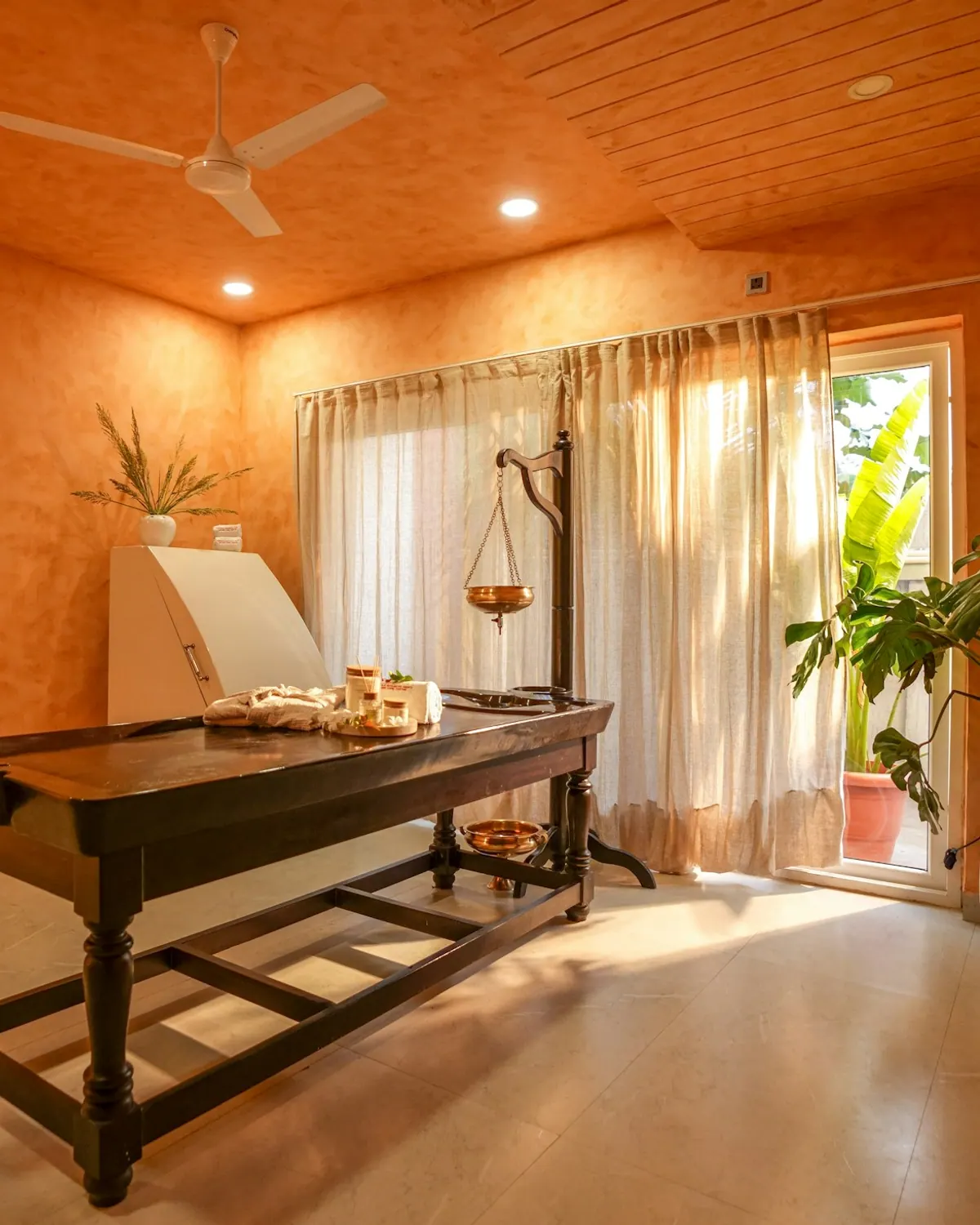 Warm private spa treatment room with a massage table