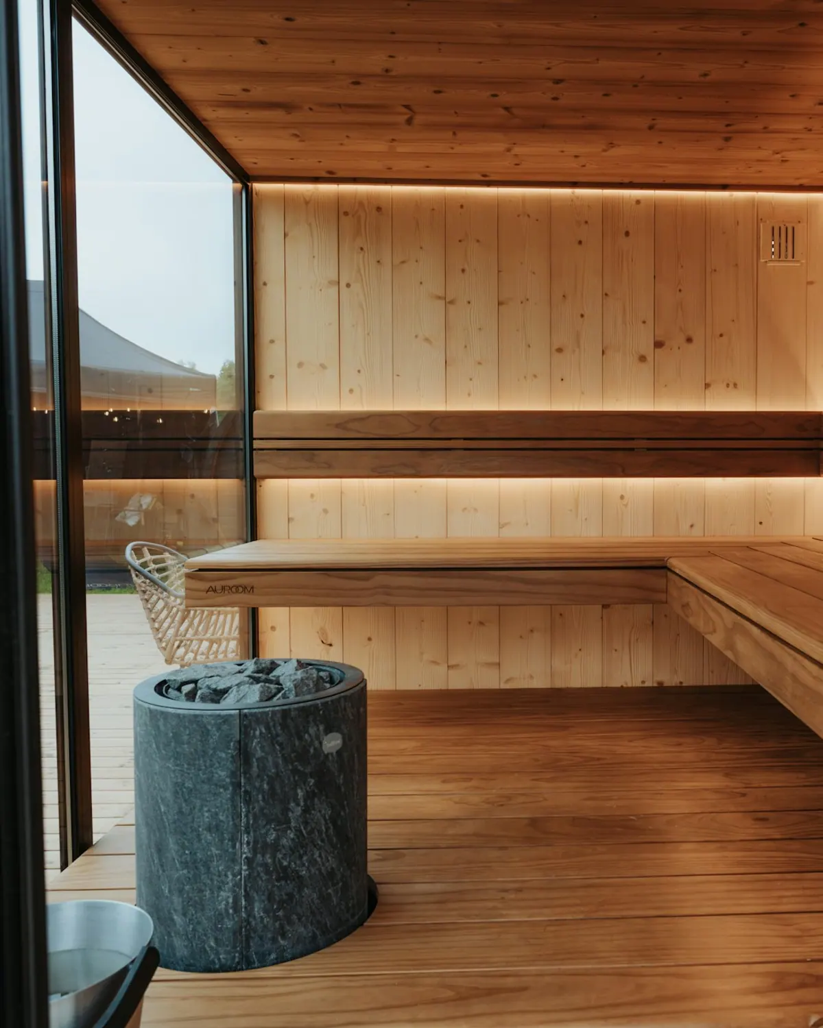 Modern private sauna room with warm wood and ambient lighting