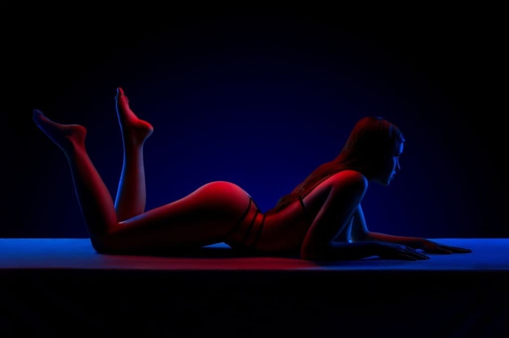 Warm oil massage strokes across the back during signature flow service