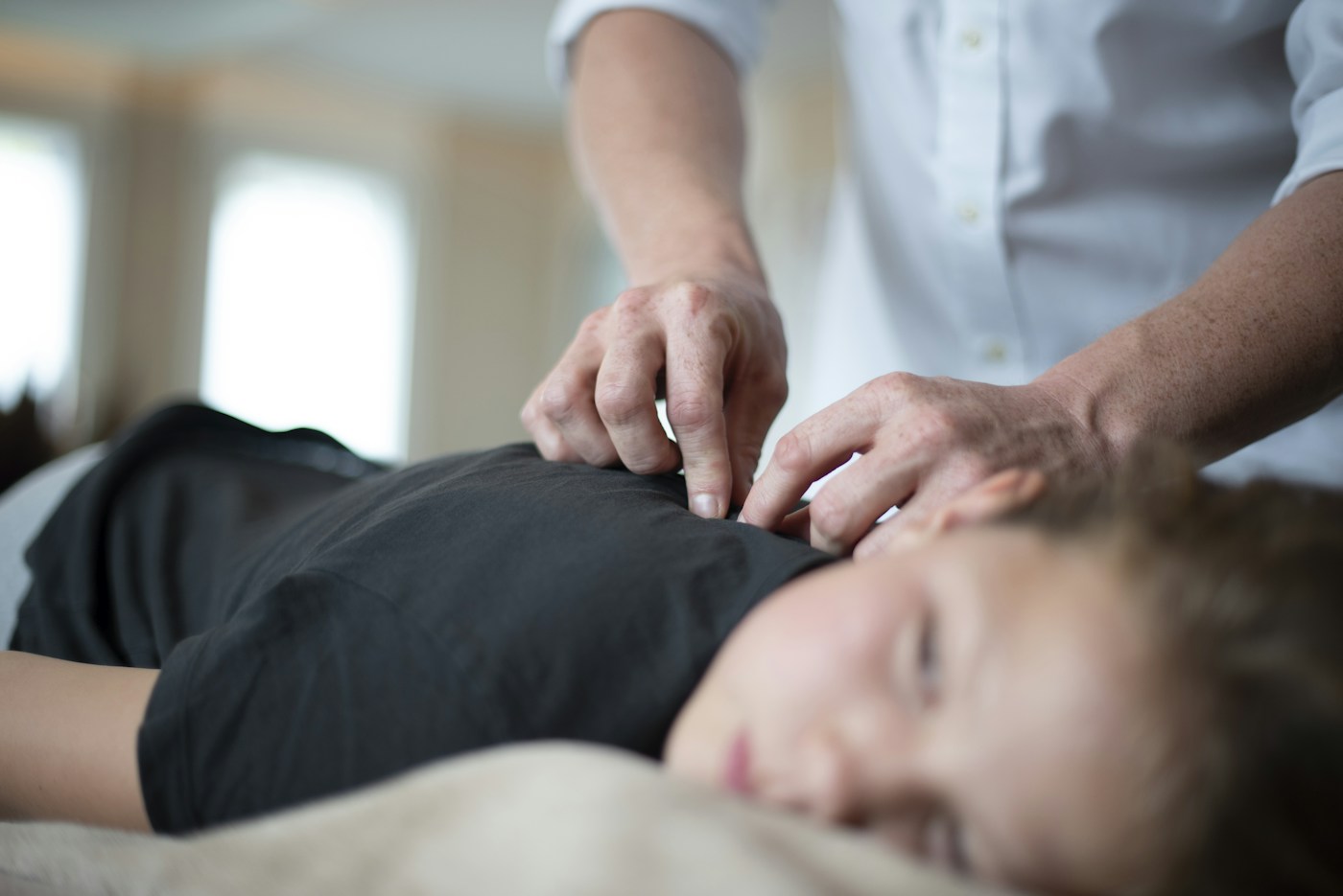 A gentle shoulder treatment on a massage table